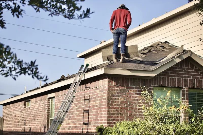 Professional roofer working on a residential roof in Marriottsville